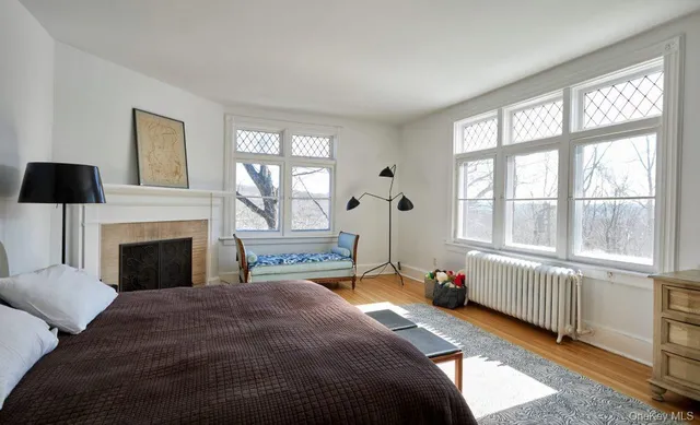 a bedroom with a bed and a large window