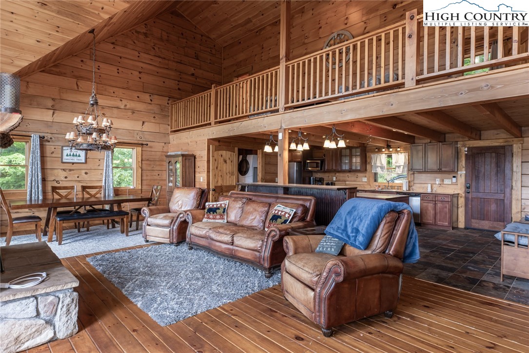 595 Little Squirrel Creek Road Newland, NC 28657 - Photo 15 of 49 a outdoor living area with furniture and wooden floor