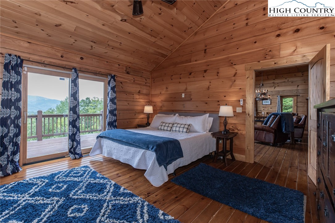 595 Little Squirrel Creek Road Newland, NC 28657 - Photo 16 of 49 a spacious bedroom with a bed and wooden floor