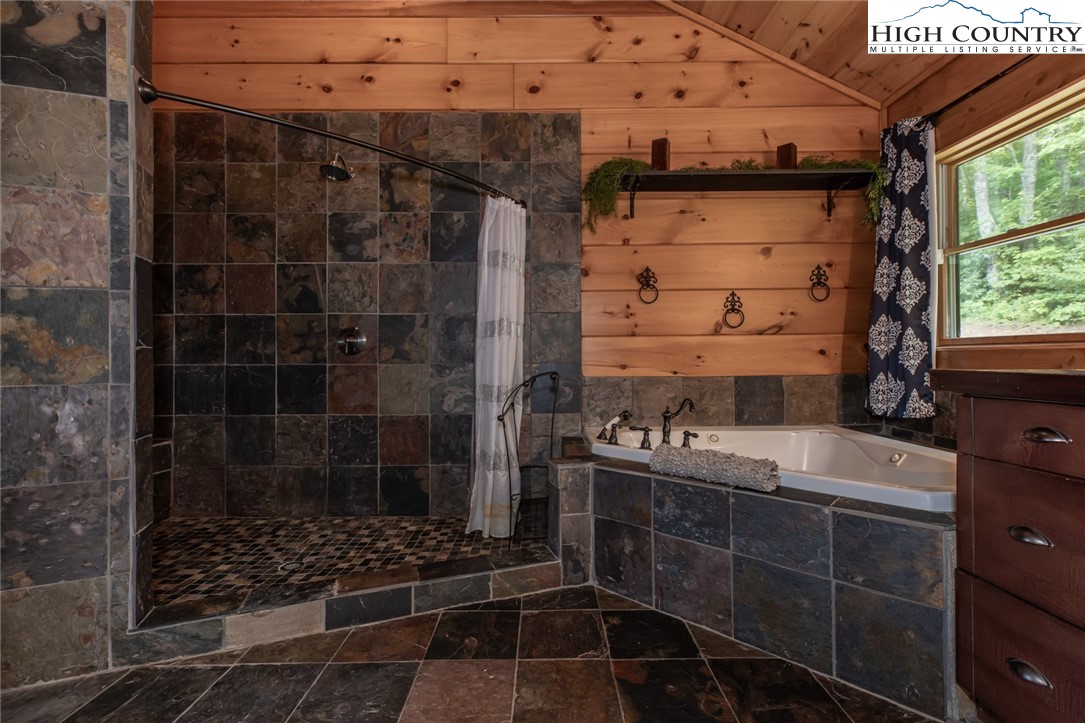 595 Little Squirrel Creek Road Newland, NC 28657 - Photo 19 of 49 a bathroom with a sink toilet and shower