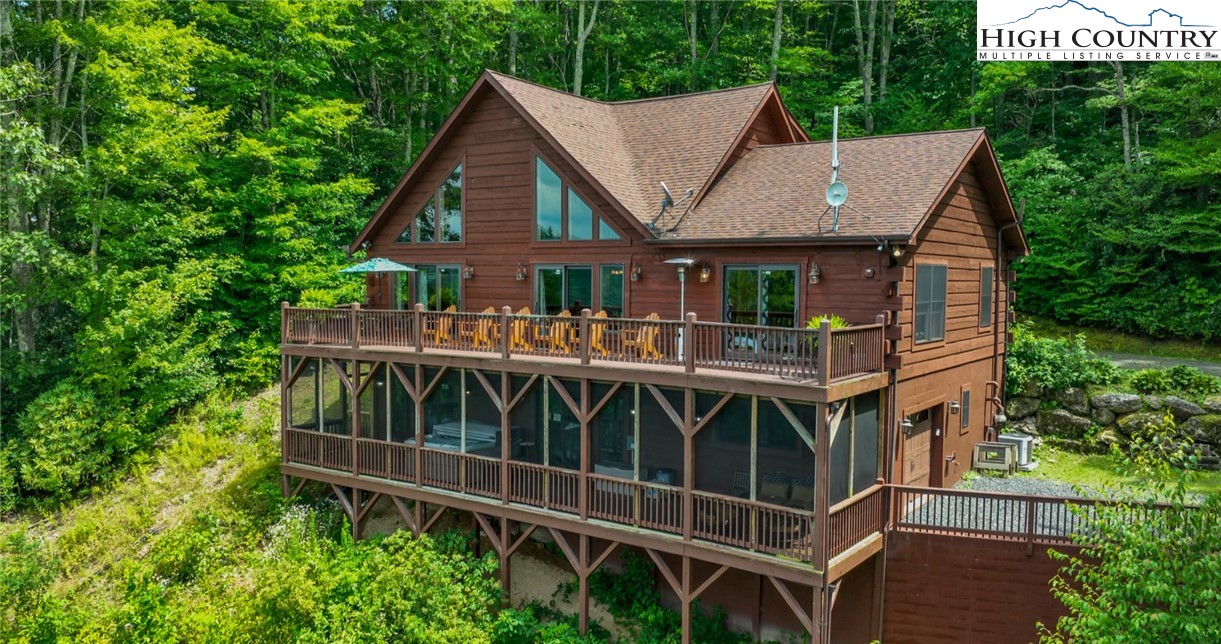 595 Little Squirrel Creek Road Newland, NC 28657 - Photo 2 of 49 a view of a house with wooden deck and backyard