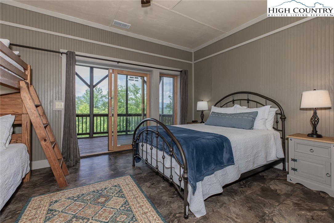 595 Little Squirrel Creek Road Newland, NC 28657 - Photo 37 of 49 a bedroom with a large bed and a large window