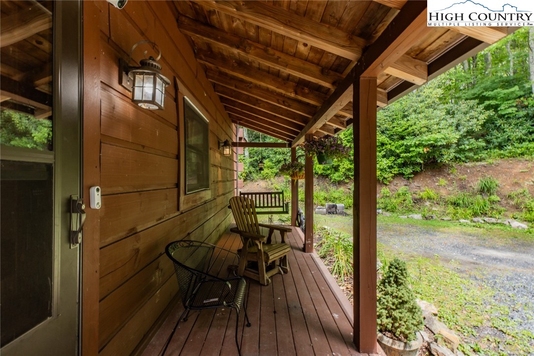 595 Little Squirrel Creek Road Newland, NC 28657 - Photo 47 of 49 a view of a balcony with chairs and wooden floor