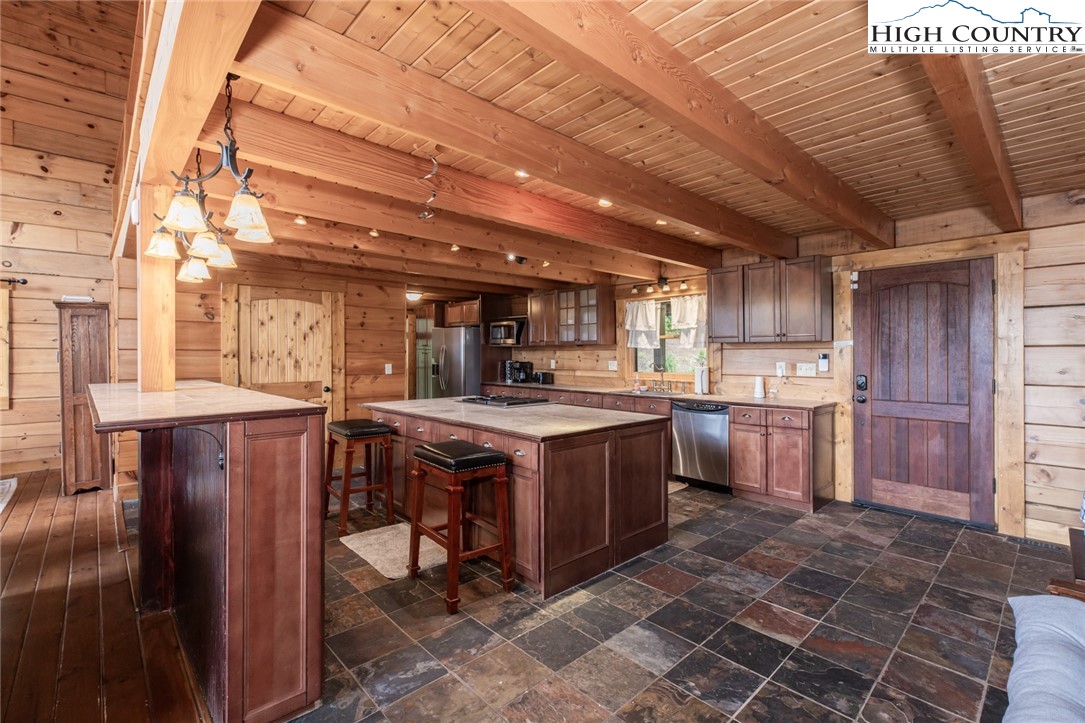 595 Little Squirrel Creek Road Newland, NC 28657 - Photo 7 of 49 a kitchen with appliances cabinets and furniture