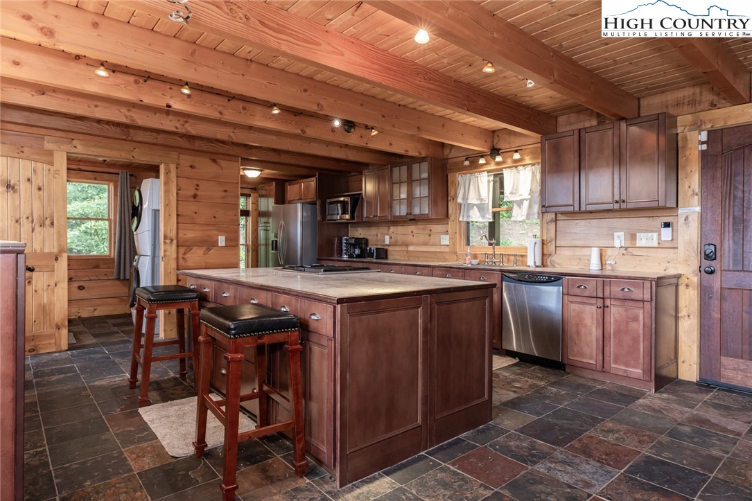 595 Little Squirrel Creek Road Newland, NC 28657 - Photo 8 of 49 a kitchen with stainless steel appliances granite countertop a stove a sink dishwasher and cabinets