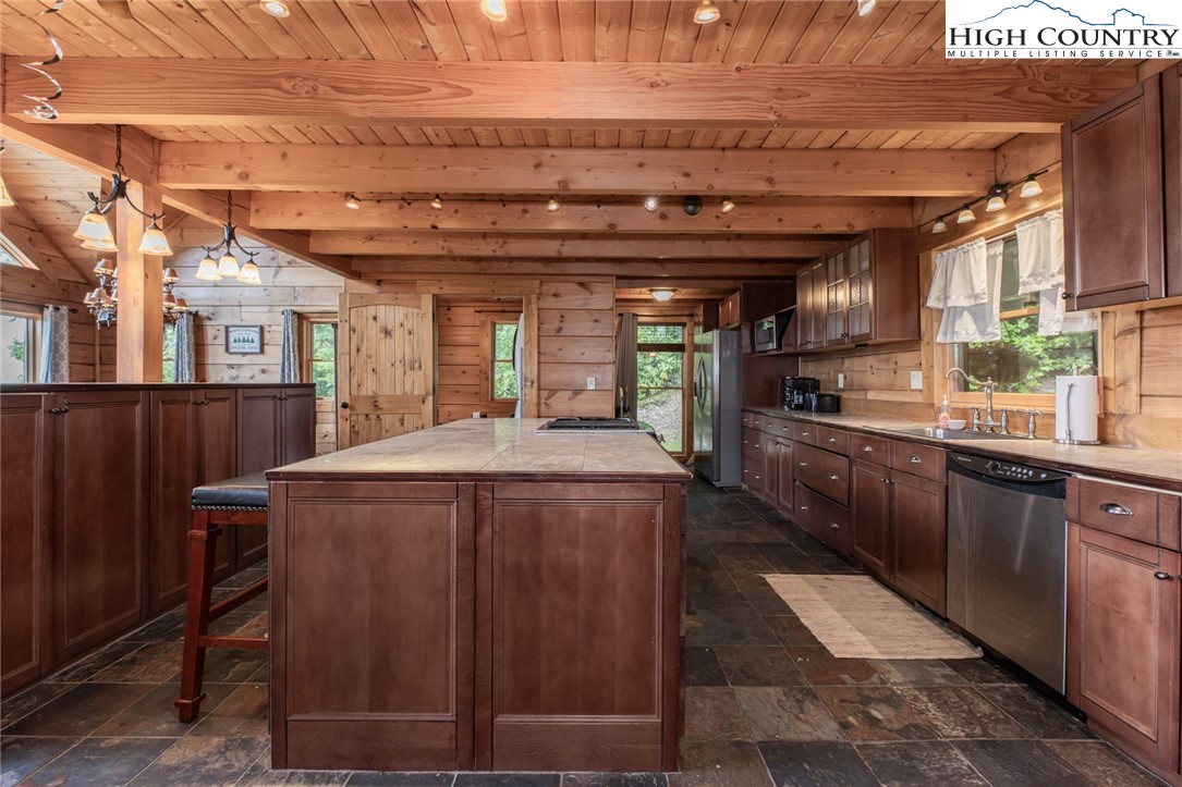 595 Little Squirrel Creek Road Newland, NC 28657 - Photo 9 of 49 a kitchen with a refrigerator and wooden cabinets