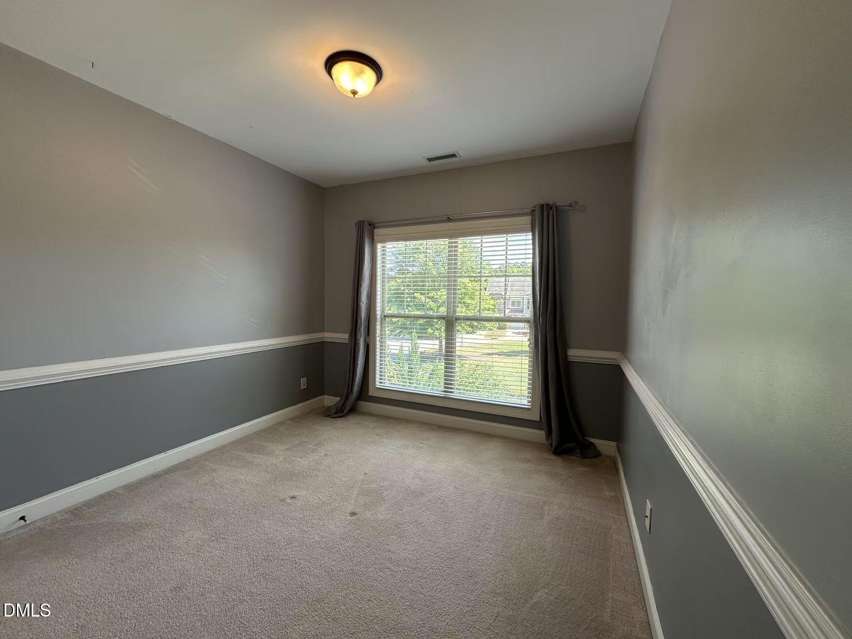 1056 Indigo Ridge Place Cary, NC 27519 - Photo 22 of 33 an empty room with a empty space and a window