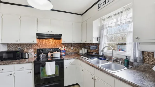 a kitchen with a sink stove and cabinets