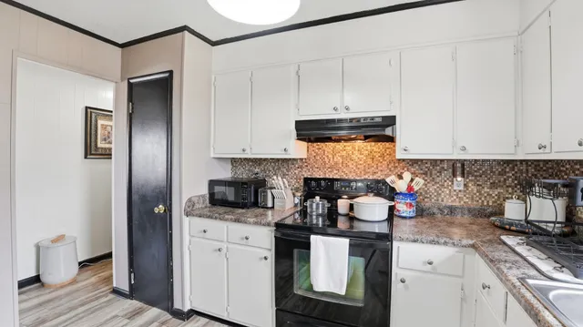 a kitchen with stainless steel appliances granite countertop a stove and a refrigerator