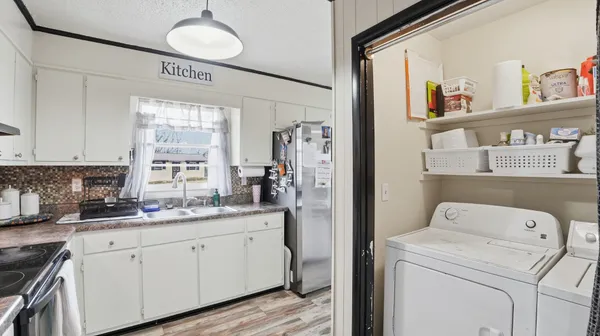 a kitchen with a sink cabinets and a window