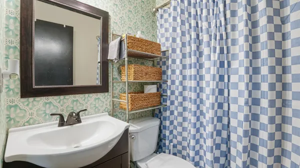 a bathroom with a sink toilet and mirror