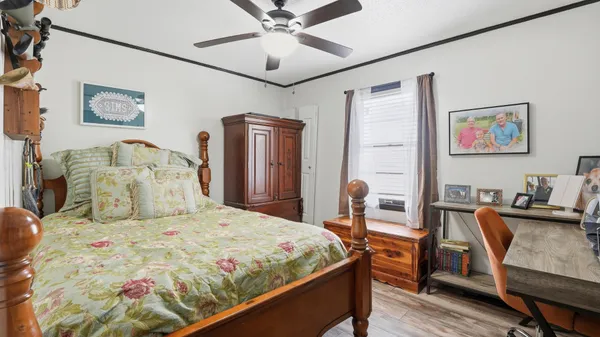 a bedroom with a bed and a desk