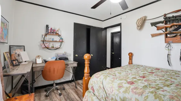 a bedroom with bed and a chandelier