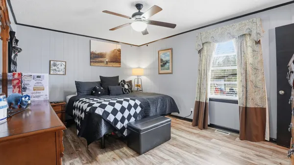 a bedroom with a large bed and a window