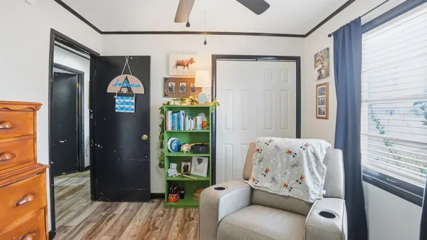 a view of a patio with table and chairs near a barbeque