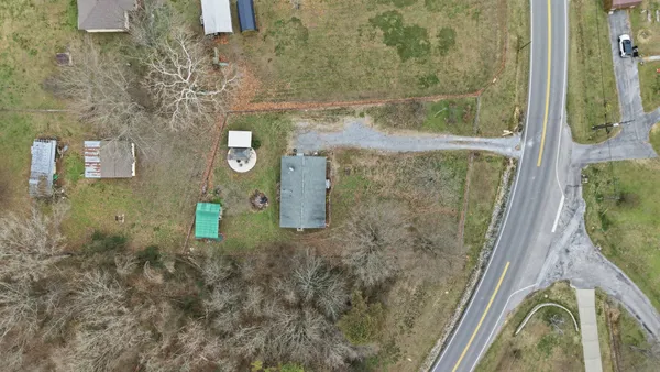 an aerial view of a house with a yard