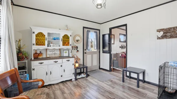 a view of living room with furniture and wooden floor