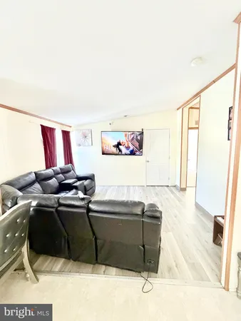 a view of living room with furniture and a fireplace