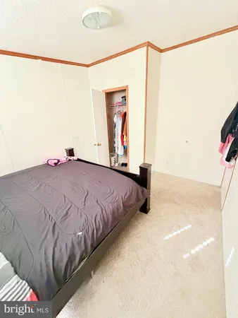 a bedroom with bed and window