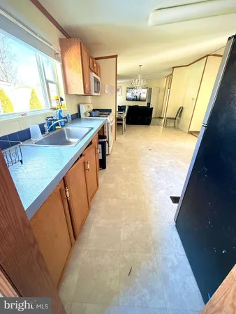 a view of an empty room with furniture and a flat screen tv