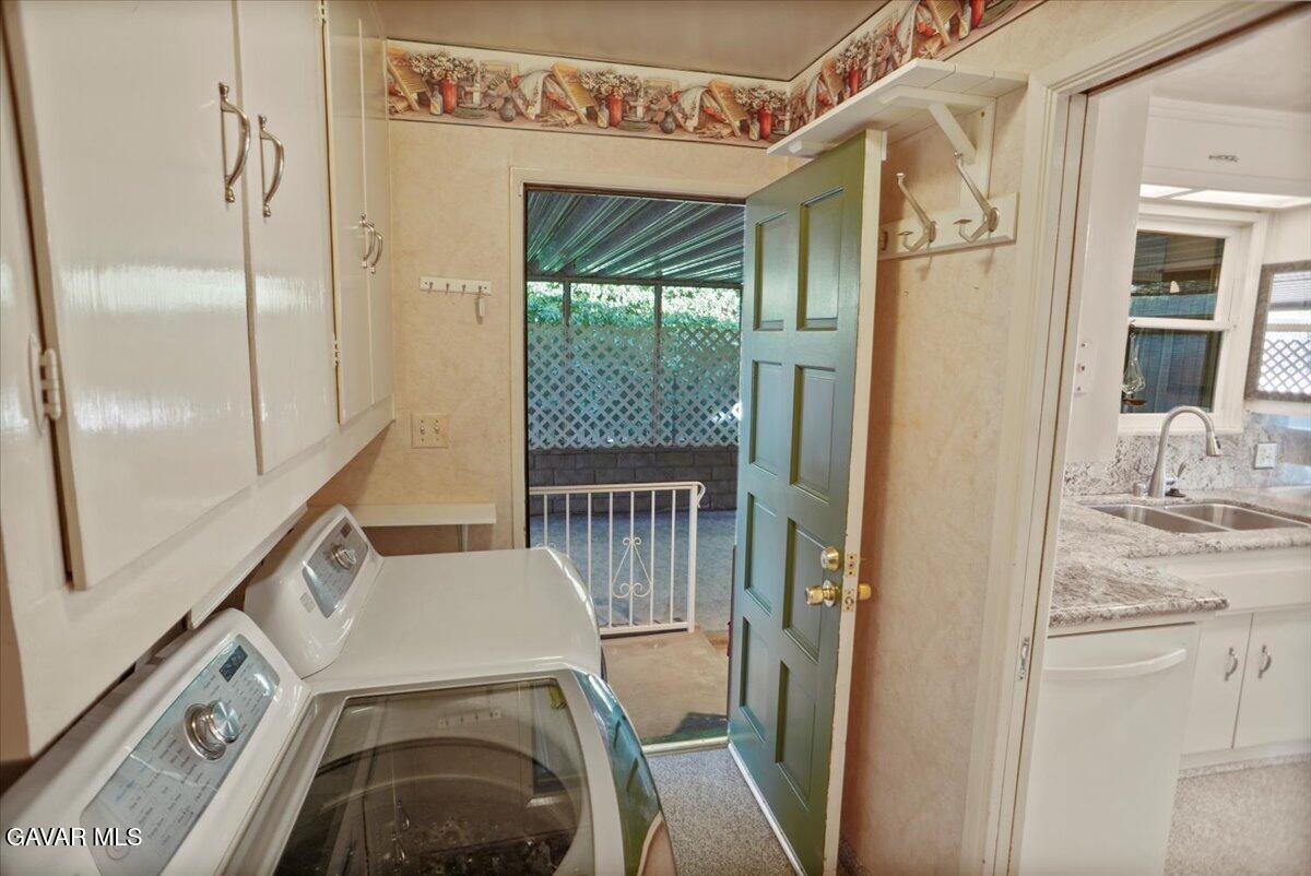 719 West Ave J-10 Lancaster, CA 93534 - Photo 13 of 21 a view of a hallway with washer and dryer