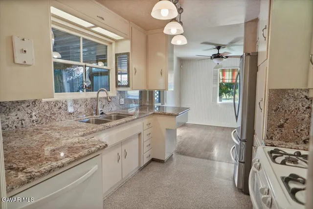 a bathroom with a granite countertop sink and a window