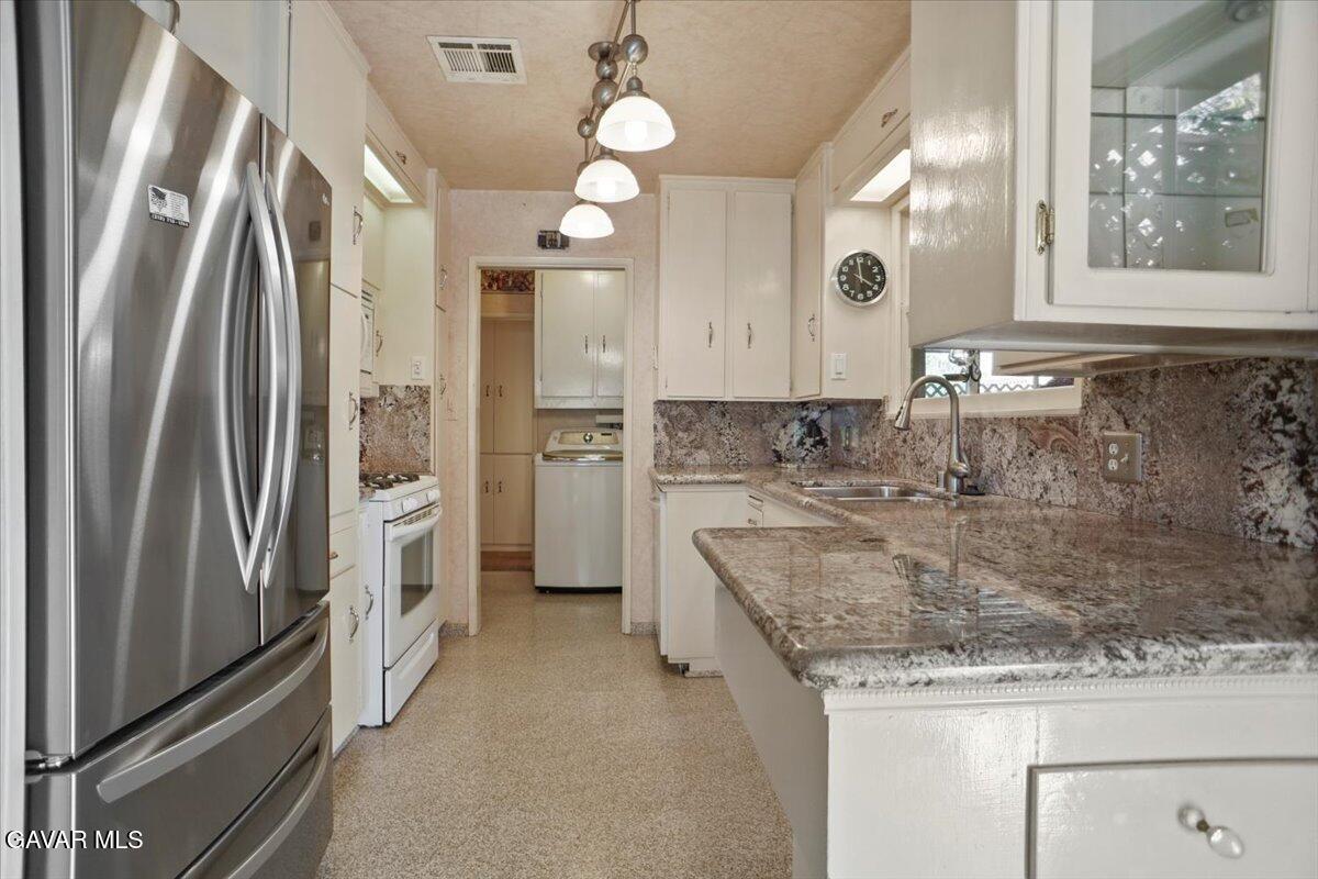 719 West Ave J-10 Lancaster, CA 93534 - Photo 5 of 21 a bathroom with a granite countertop sink mirror and shower