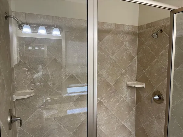 a bathroom with a glass shower door
