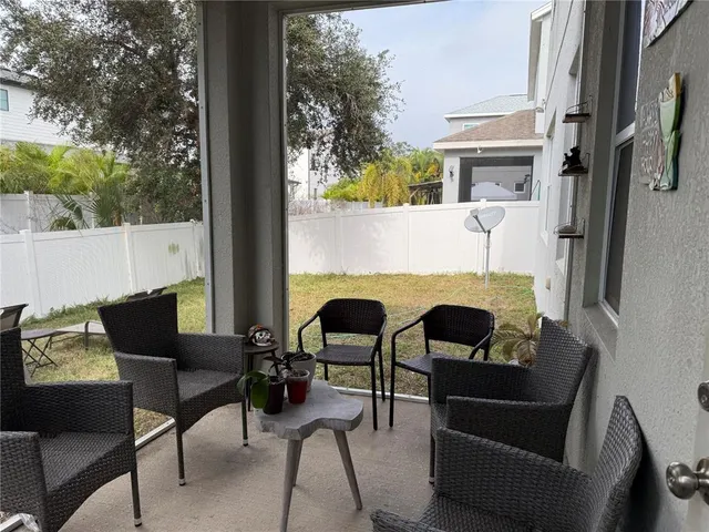 a view of a patio with couple of chairs and a couch