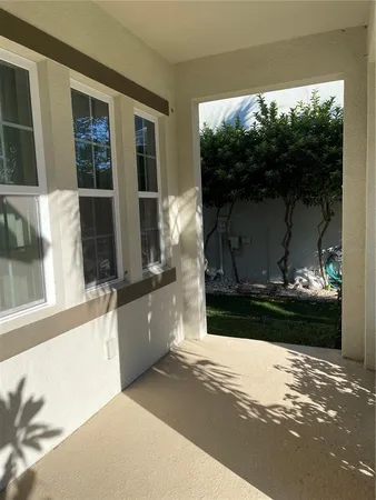 a living room with a fireplace and a floor to ceiling window