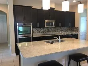 a kitchen with a sink and a refrigerator