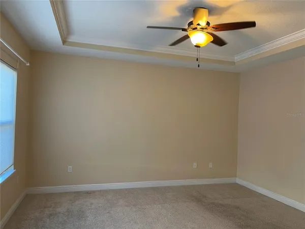 a view of a small space with a chandelier fan