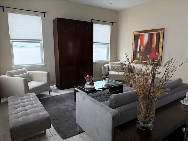 a living room with furniture and a potted plant