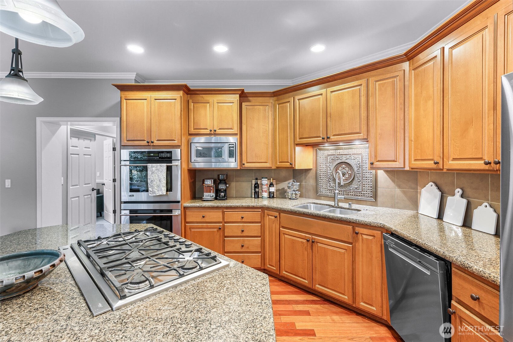 2029 240th Place Southeast Bothell, WA 98021 - Photo 12 of 39 a kitchen with stainless steel appliances granite countertop a stove a sink and a microwave