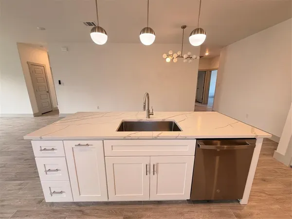a kitchen with a sink and cabinets