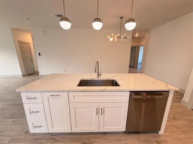 a kitchen with a sink and cabinets