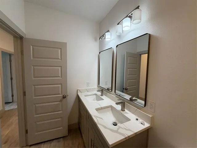 a bathroom with a sink vanity and a mirror