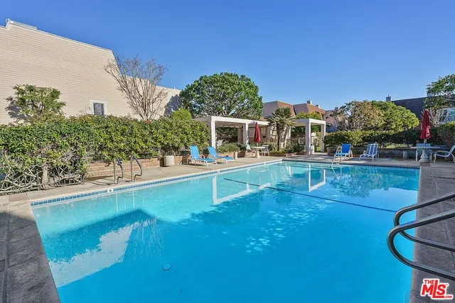a swimming pool with outdoor seating and yard