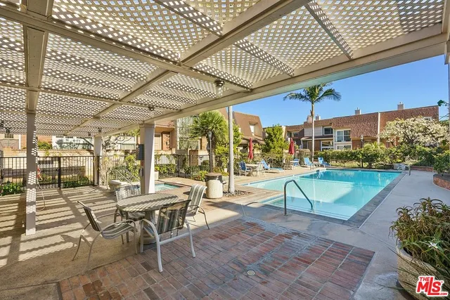 a view of a patio with a table and chairs