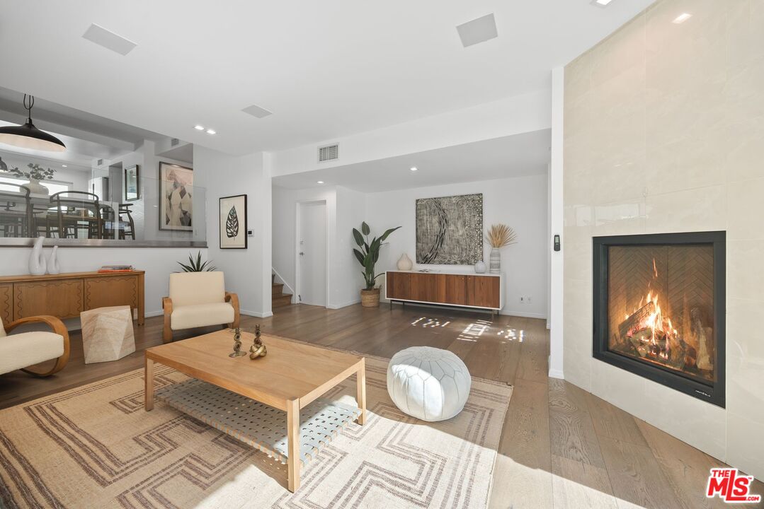 13065 Mindanao Way, Unit 3 Marina del Rey, CA 90292 - Photo 4 of 25 a living room with furniture a rug and wall paintings