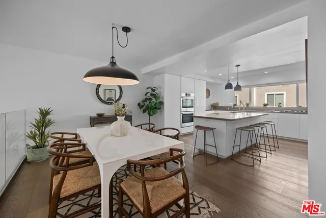 a view of a dining room with furniture wooden floor and chandelier
