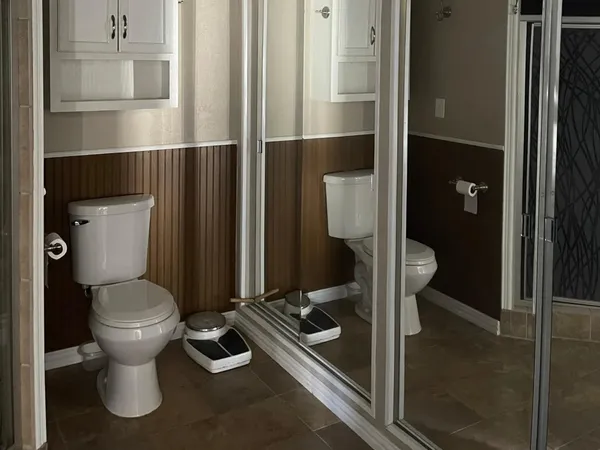 a bathroom with a toilet and a shower