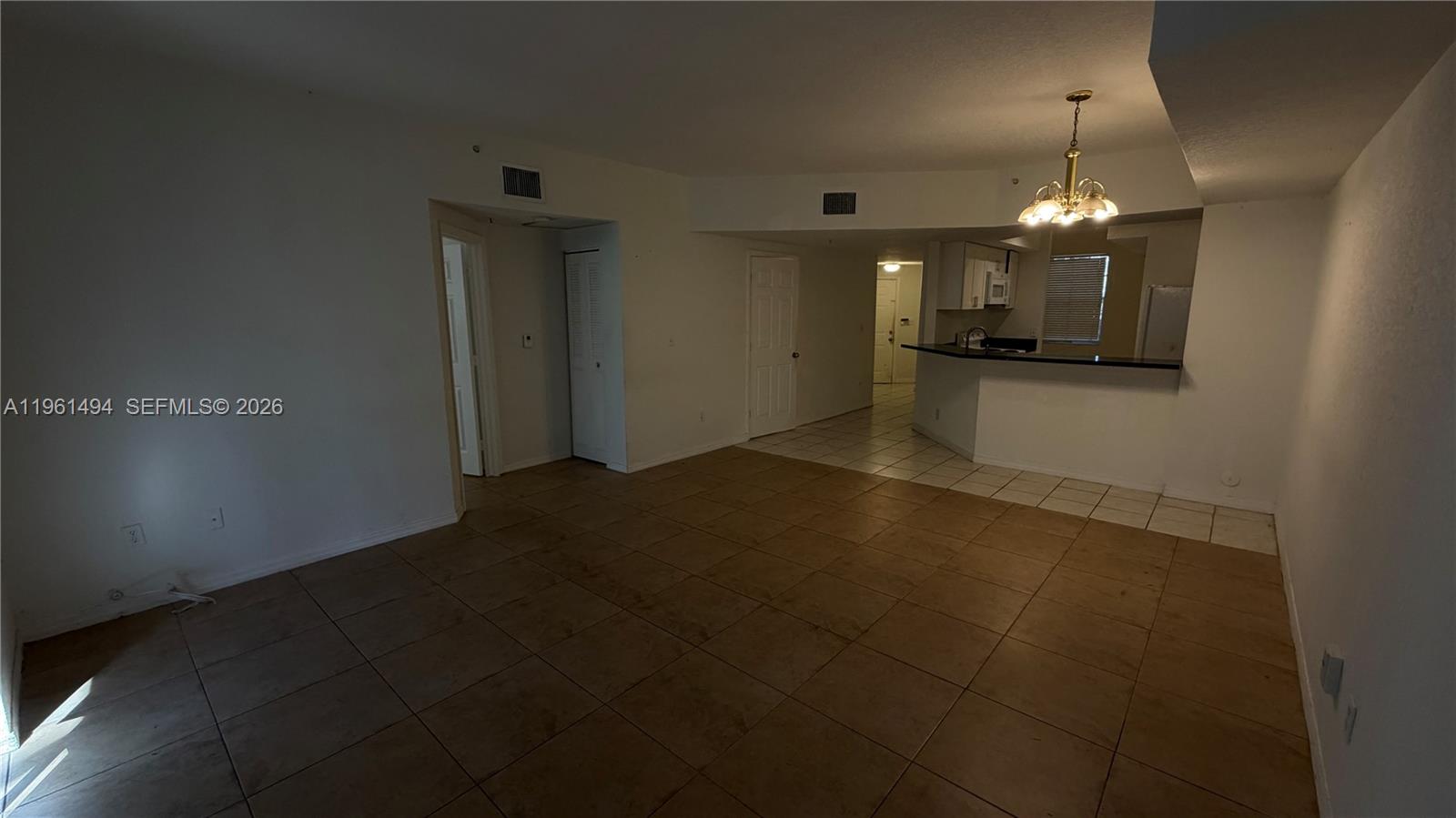 741 Southwest 148th Avenue, Unit 705 Sunrise, FL 33325 - Photo 12 of 32 a view of a livingroom with a kitchen