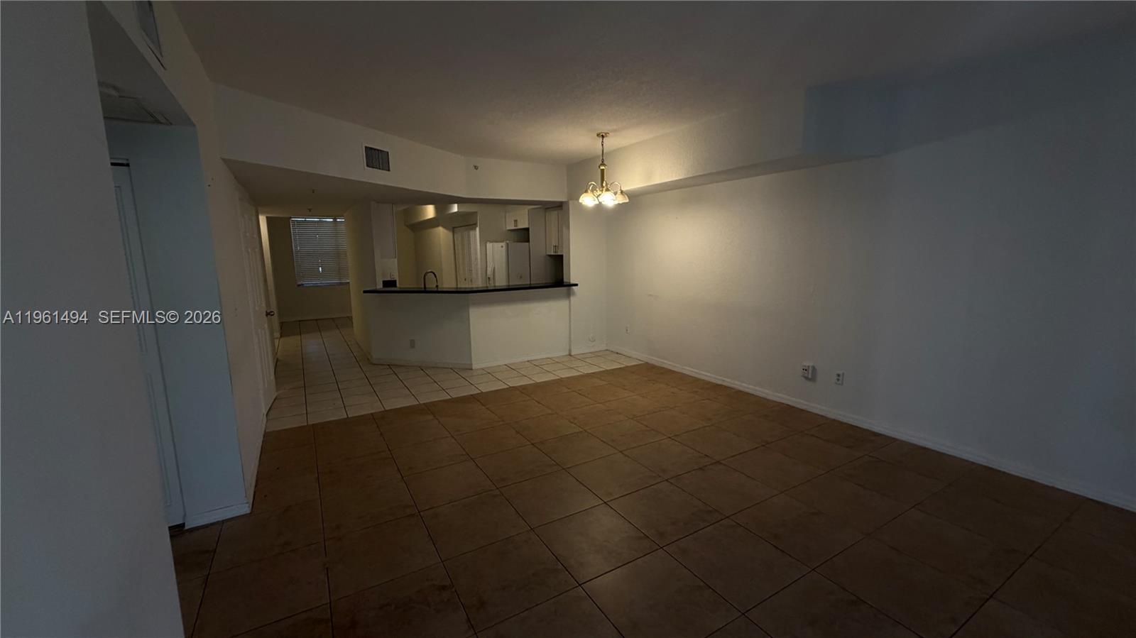741 Southwest 148th Avenue, Unit 705 Sunrise, FL 33325 - Photo 13 of 32 an empty room with wooden floor and windows