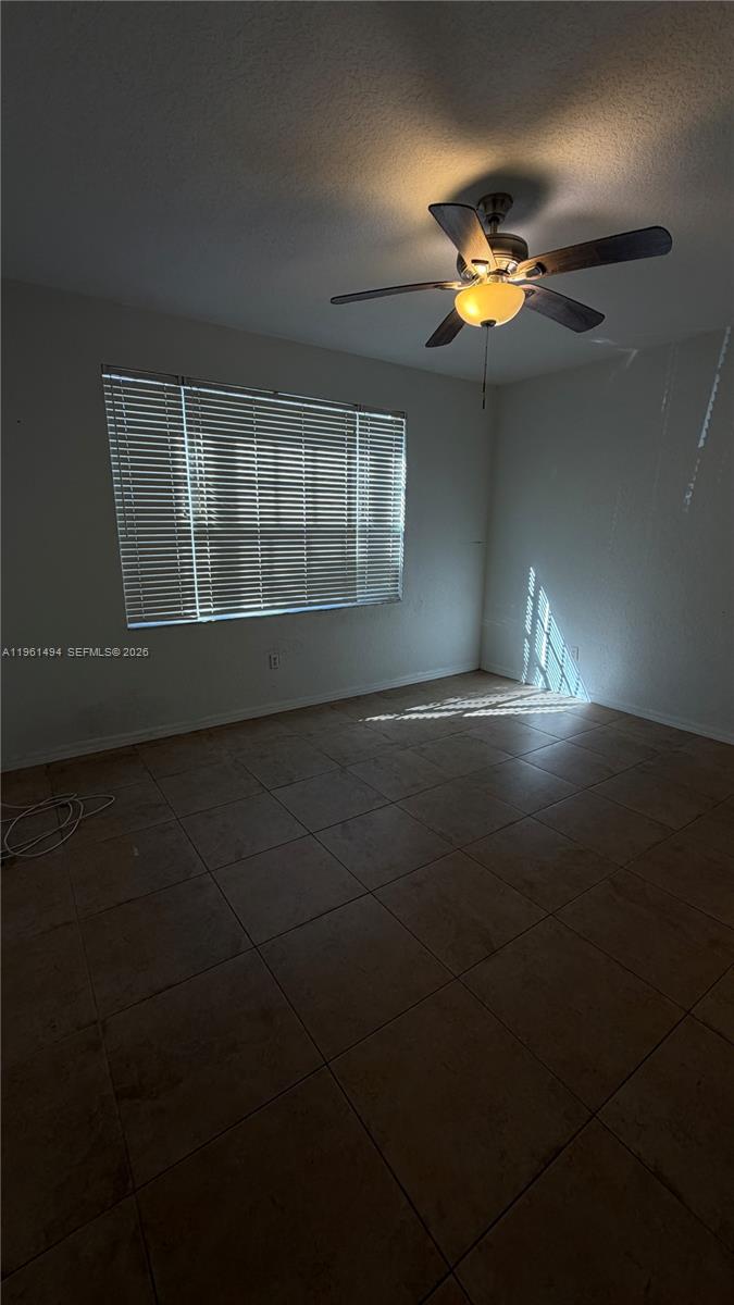 741 Southwest 148th Avenue, Unit 705 Sunrise, FL 33325 - Photo 15 of 32 a view of room with a ceiling fan and window