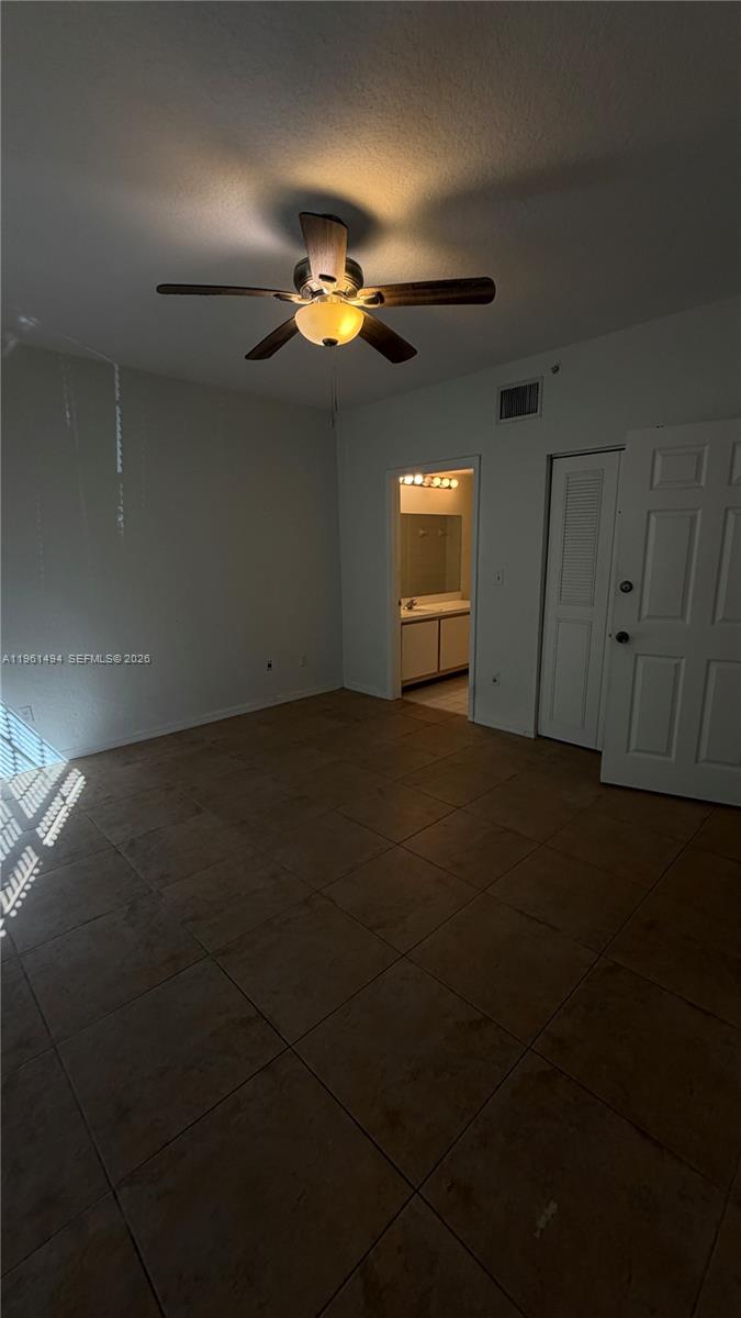 741 Southwest 148th Avenue, Unit 705 Sunrise, FL 33325 - Photo 16 of 32 an empty room with a chandelier fan and windows