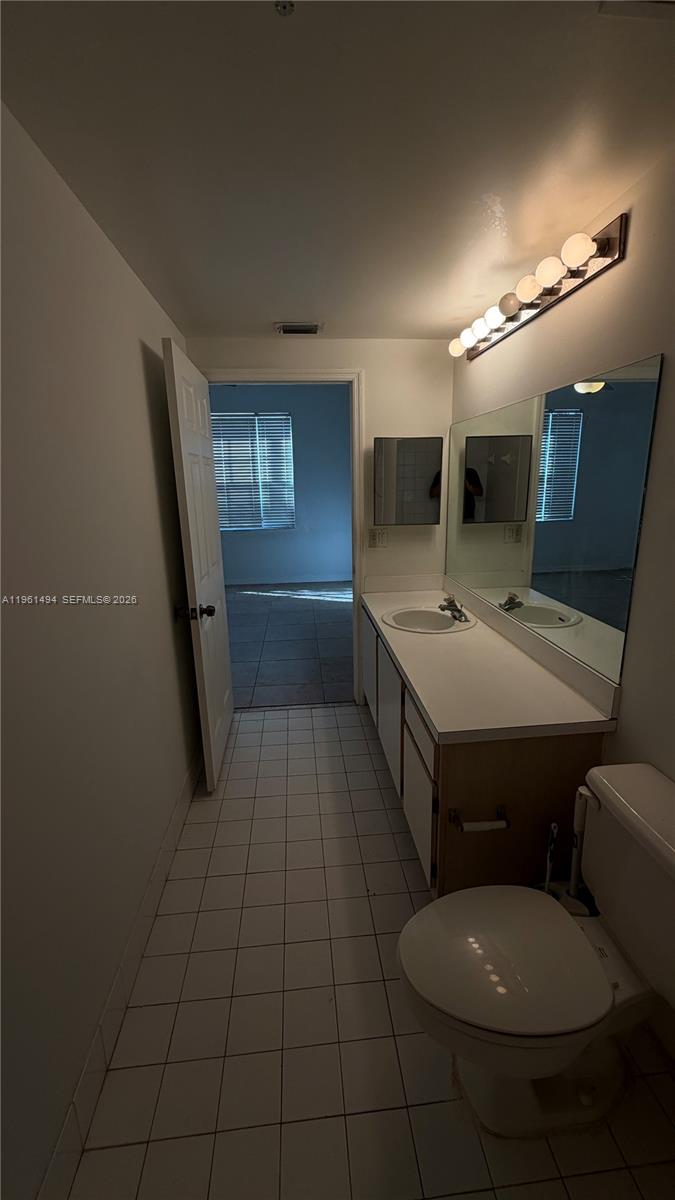 741 Southwest 148th Avenue, Unit 705 Sunrise, FL 33325 - Photo 18 of 32 a bathroom with a sink a toilet a mirror and bathtub