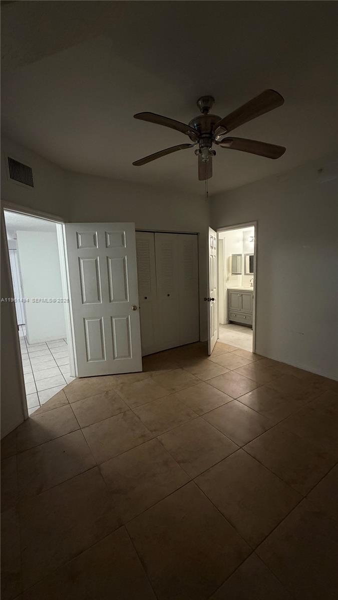 741 Southwest 148th Avenue, Unit 705 Sunrise, FL 33325 - Photo 22 of 32 a view of a livingroom with a ceiling fan and window