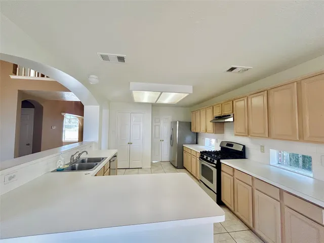 a large kitchen with stainless steel appliances
