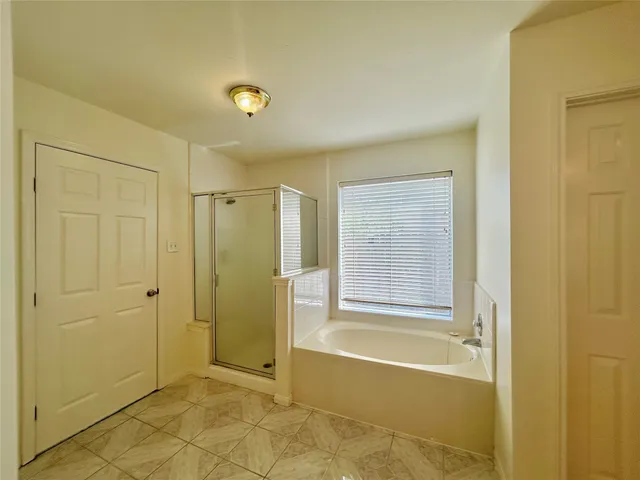 walk in closet with white walls